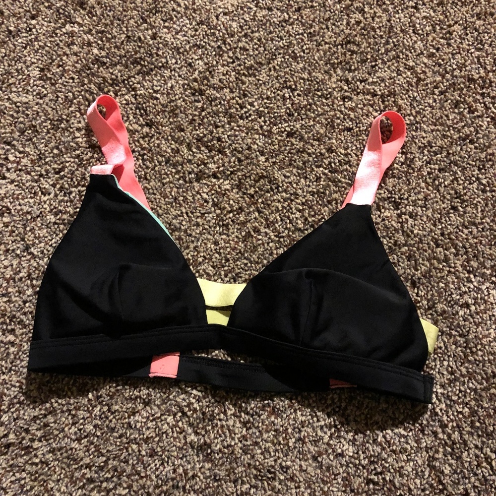black swimsuit top with neon cage back